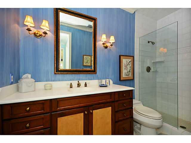 23 West High Point Road Sewall's Point, FL 34996 - Photo 16 of 25 a bathroom with a sink vanity toilet and shower
