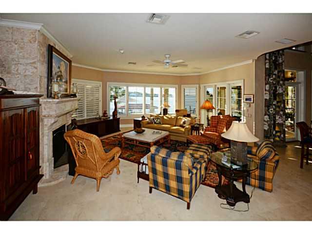 23 West High Point Road Sewall's Point, FL 34996 - Photo 5 of 25 a living room with lots of furniture and a fireplace