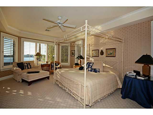 23 West High Point Road Sewall's Point, FL 34996 - Photo 9 of 25 a bedroom with a bed couch and large window