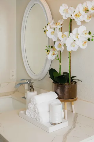 a bathroom with a sink mirror and vanity