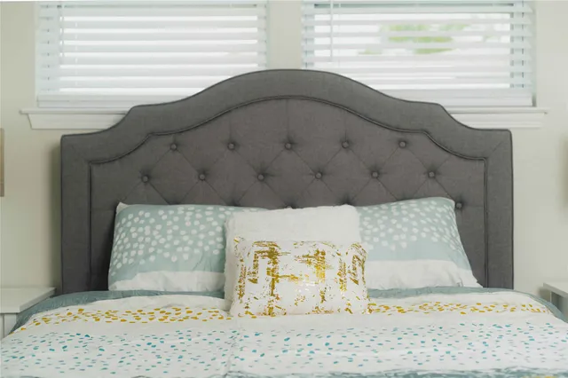 a bedroom with a bed and lamp