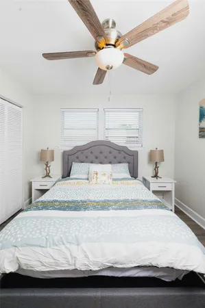 a large bed sitting in a bedroom next to a window