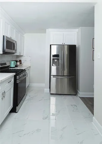 a living room with furniture a flat screen tv and a table