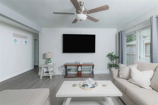 a living room with furniture and a wooden floor