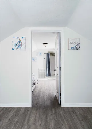 a bedroom with a bed and a night stand