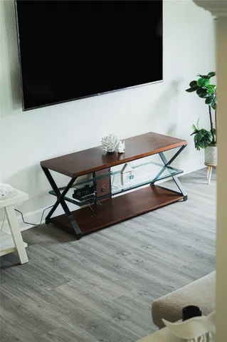 a view of a balcony with chair and wooden floor