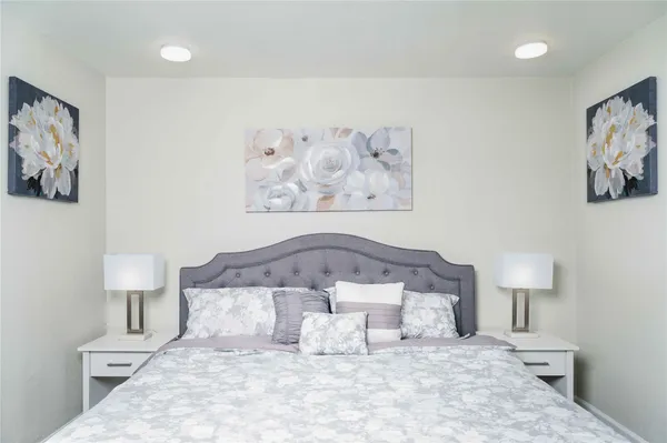 a bedroom with a bed and wall painting