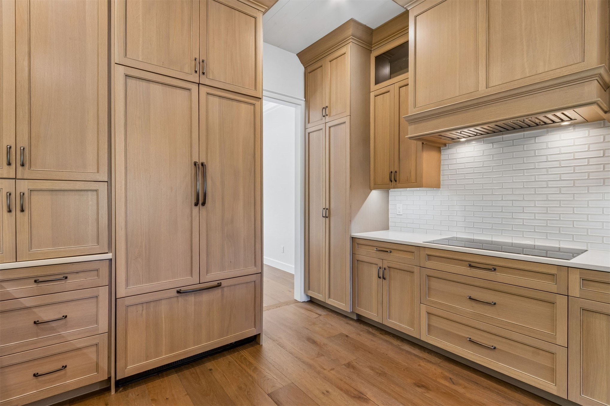4 Salt Marsh Drive Fernandina Beach, FL 32034 - Photo 11 of 60 a view of a kitchen with white cabinets and a wooden floor