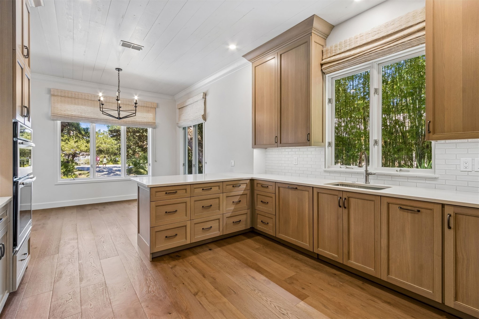 4 Salt Marsh Drive Fernandina Beach, FL 32034 - Photo 12 of 60 a kitchen with stainless steel appliances granite countertop a stove a sink dishwasher a refrigerator with wooden cabinets and wooden floor