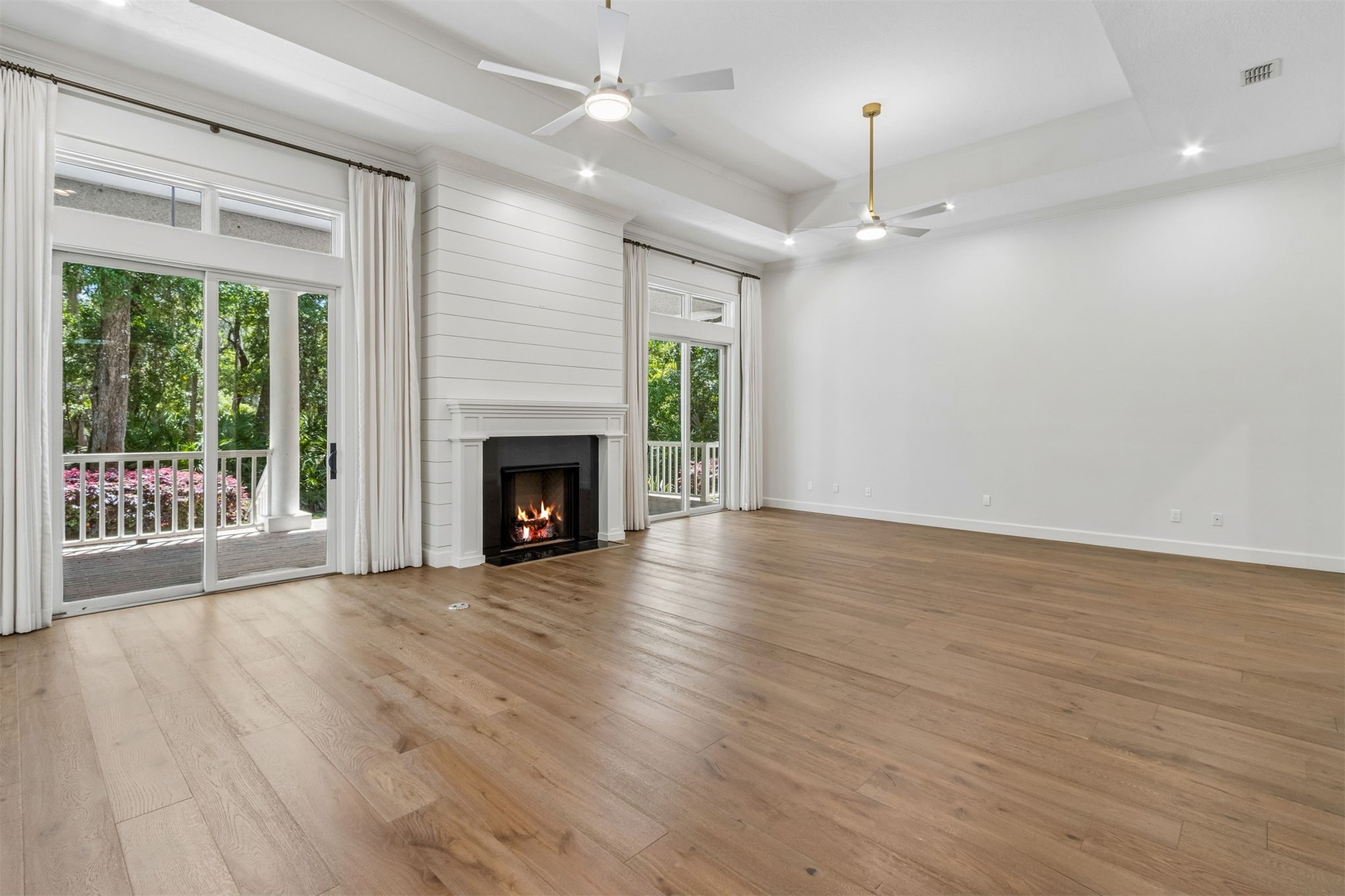 4 Salt Marsh Drive Fernandina Beach, FL 32034 - Photo 15 of 60 an empty room with wooden floor fireplace and windows