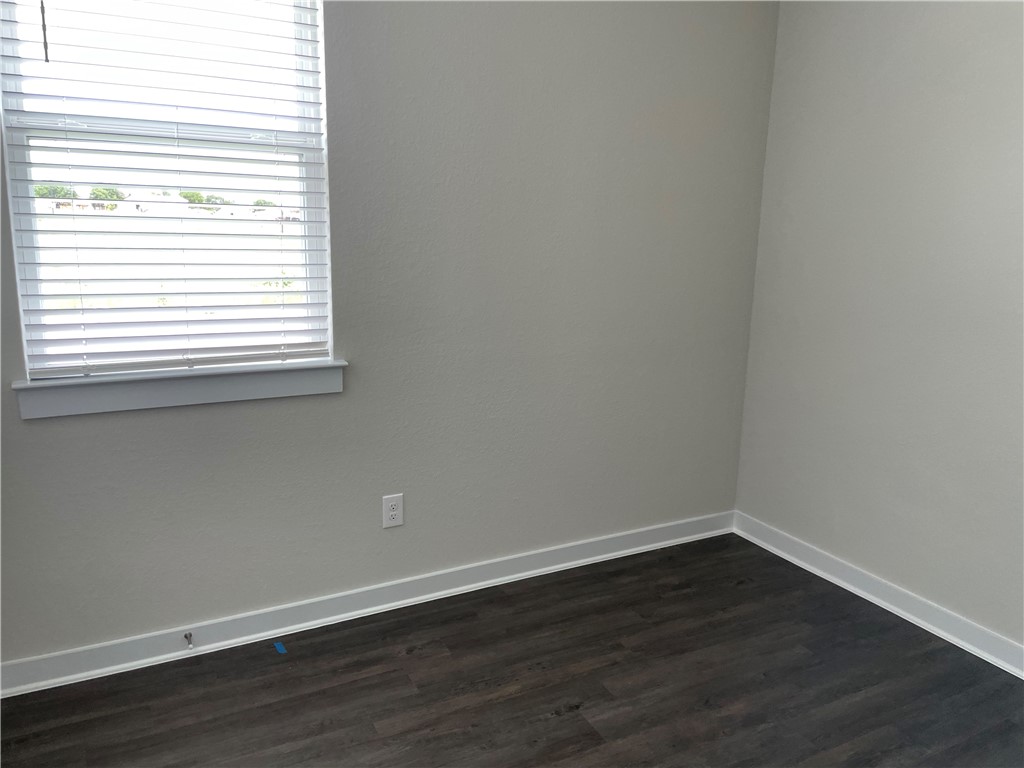 609 Paddock Lane Georgetown, TX 78626 - Photo 25 of 40 Rich dark wood flooring anchors this versatile space featuring a classic double-hung window.