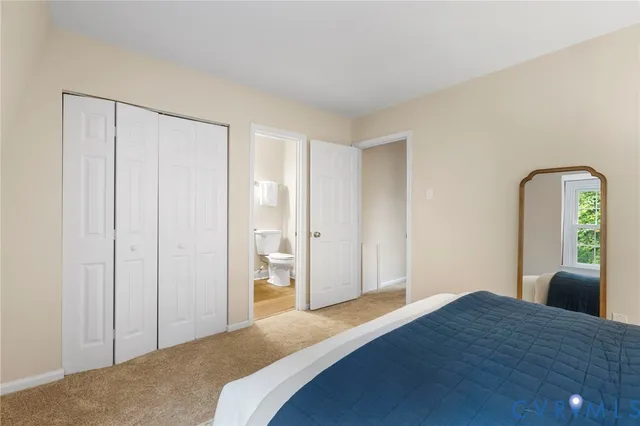 a bedroom with a bed and painting on the wall