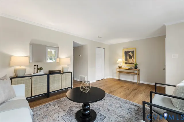 a living room with furniture and kitchen view