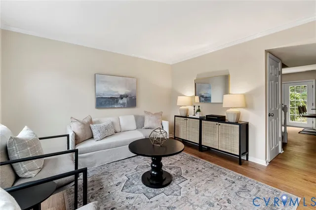 a living room with furniture and a sink