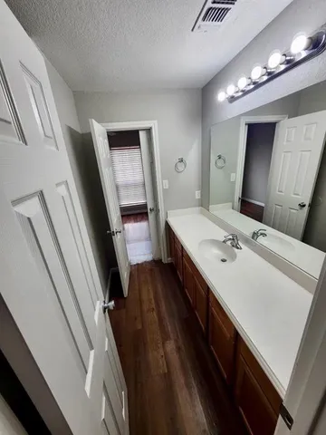 a en suite bathroom with a sink a toilet and mirror