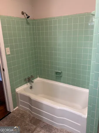 a white bath tub sitting next to a white sink