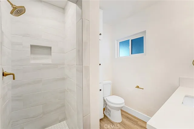 a bathroom with a toilet and a shower
