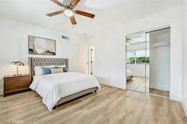 a bedroom with a large bed and a window