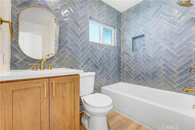 a bathroom with a toilet a sink and bathtub