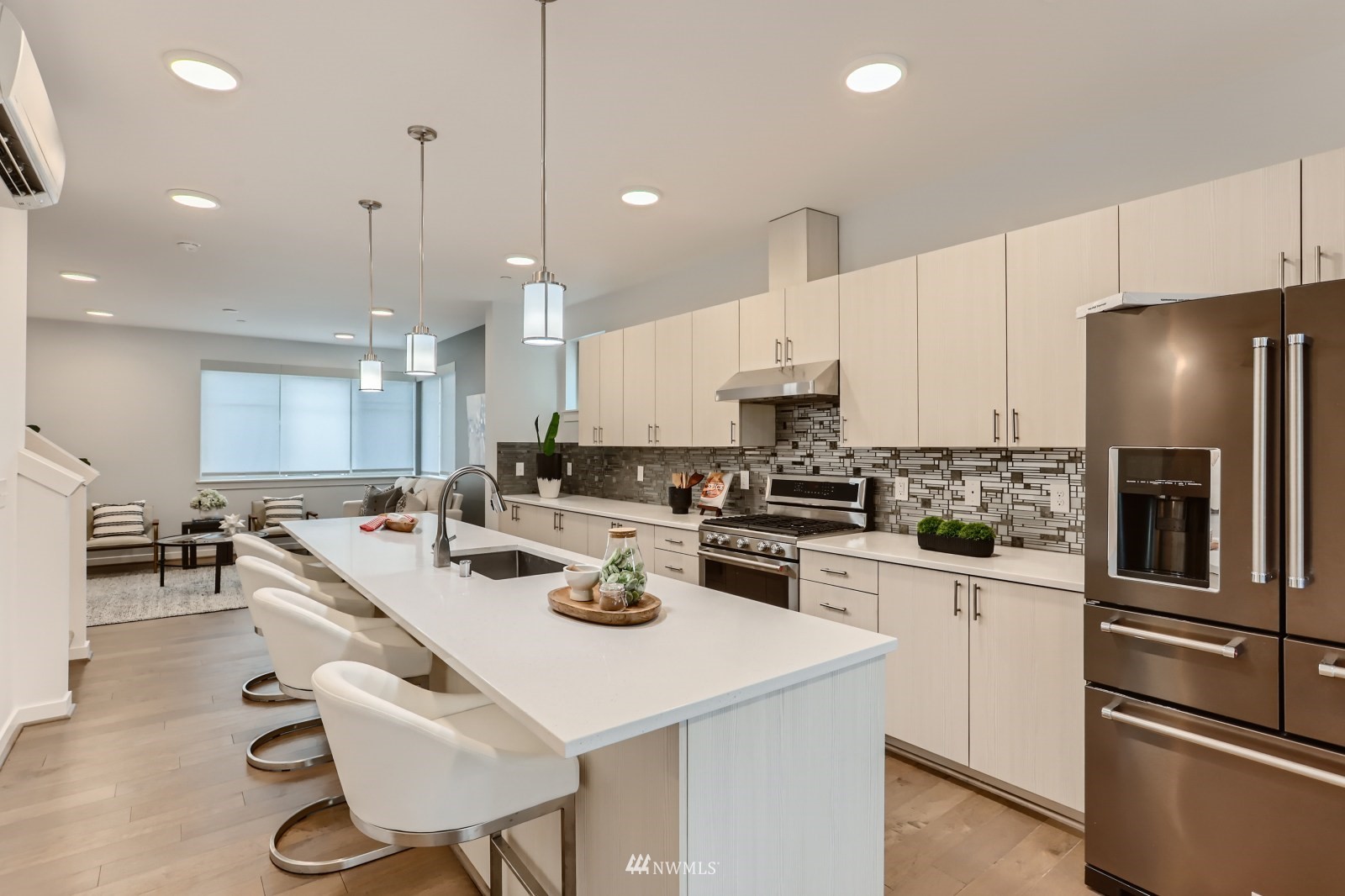 15873 Northeast 14th Road, Unit 7 7 Bellevue, WA 98008 - Photo 2 of 16 a kitchen with a sink a stove and chairs