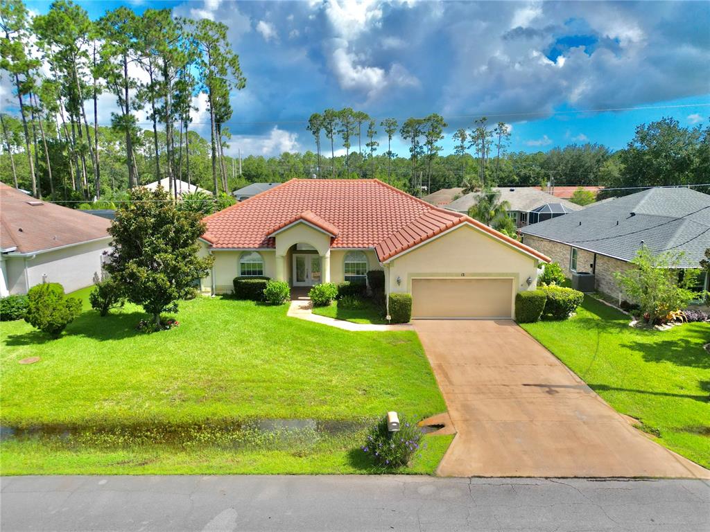 12 Essington Lane Palm Coast, FL 32164 - Photo 1 of 1 a view of yard with swimming pool and green space