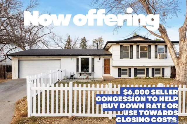 a front view of a house with a wooden fence
