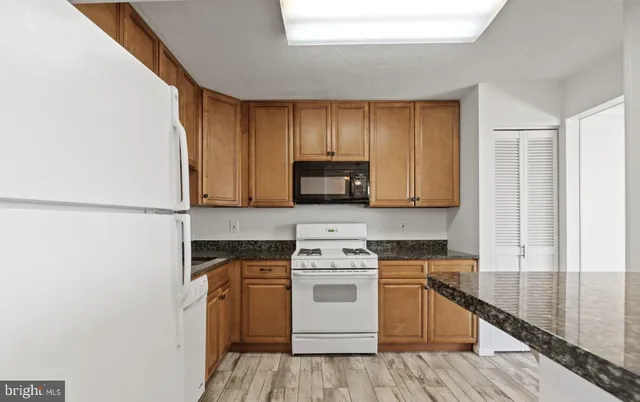 a kitchen with a stove top oven and cabinets
