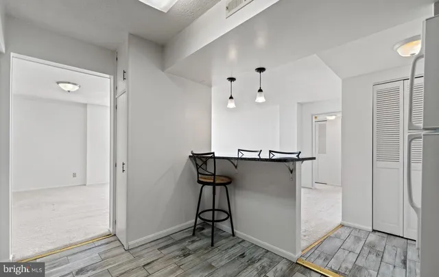 a view of a kitchen with wooden floor and staircase