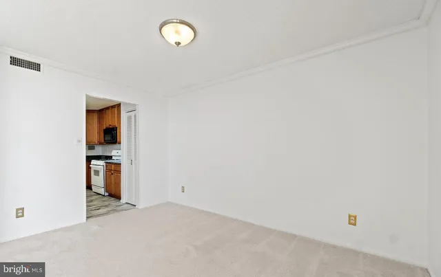 an empty room with closet and windows