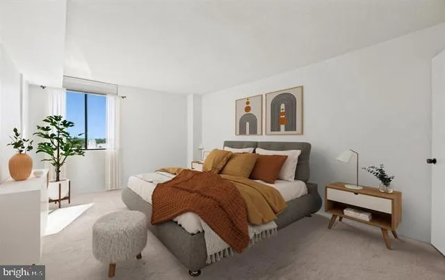 a bedroom with a bed and a potted plant