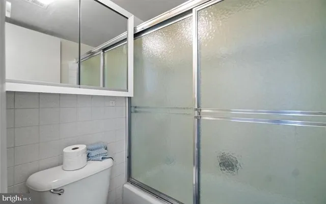 a bathroom with a shower and toilet