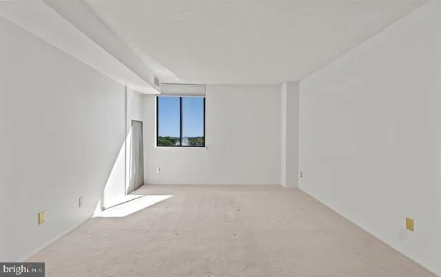 a view of an empty room with a window