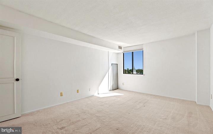 118 Monroe Street, Unit 1181109 Rockville, MD 20850 - Photo 26 of 41 a view of an empty room with a window