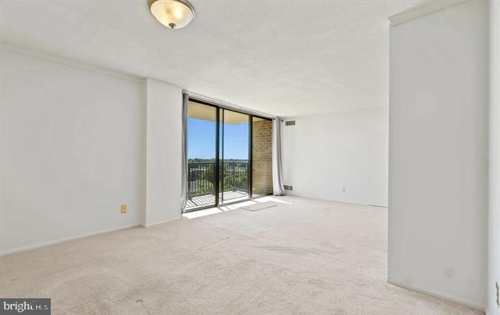 118 Monroe Street, Unit 1181109 Rockville, MD 20850 - Photo 5 of 41 a view of an empty room with wooden floor and windows