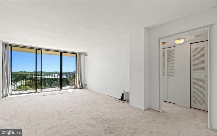 118 Monroe Street, Unit 1181109 Rockville, MD 20850 - Photo 6 of 41 an empty room with sliding glass door and mountain view