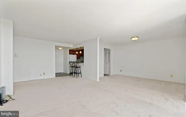 an empty room with furniture and a window