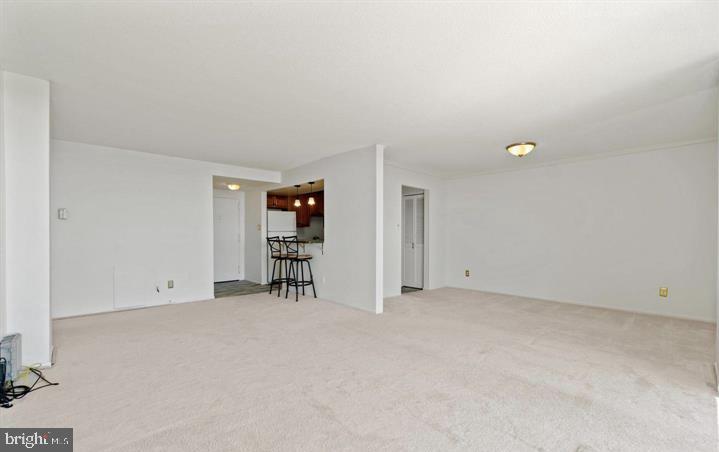 118 Monroe Street, Unit 1181109 Rockville, MD 20850 - Photo 8 of 41 an empty room with furniture and a window