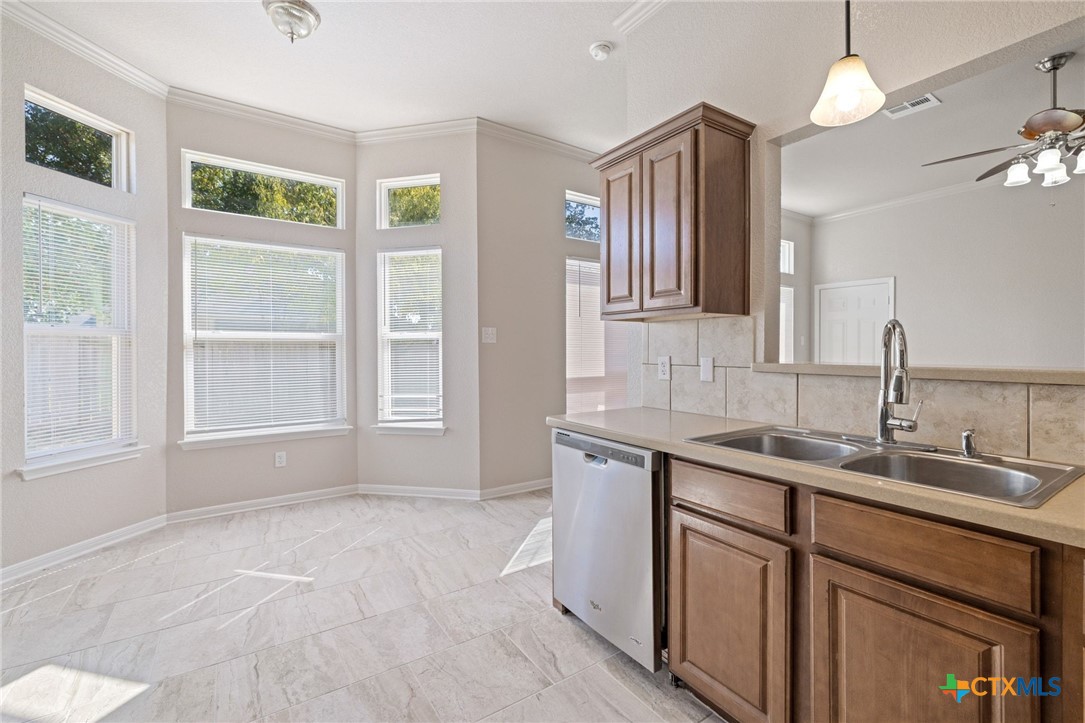 5607 Aberdeen Court Temple, TX 76502 - Photo 12 of 30 a kitchen with a sink and chandelier