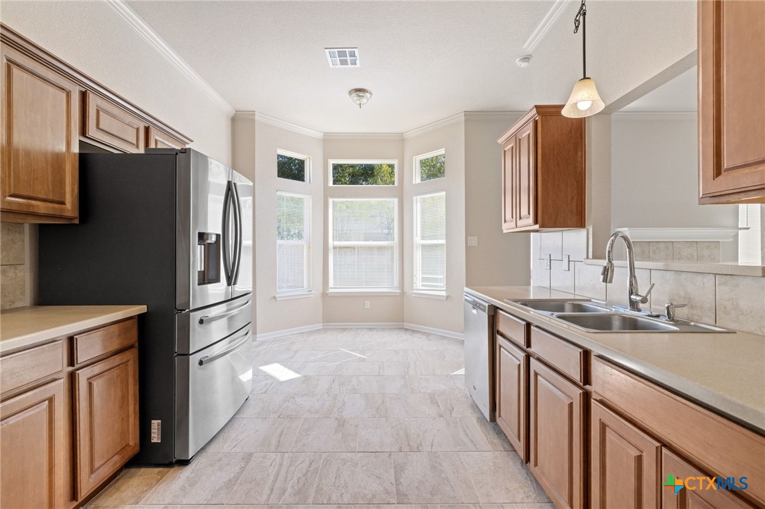 5607 Aberdeen Court Temple, TX 76502 - Photo 13 of 30 a kitchen with stainless steel appliances granite countertop a refrigerator a stove a sink and a refrigerator