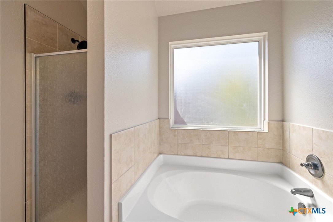 5607 Aberdeen Court Temple, TX 76502 - Photo 16 of 30 a white bath tub sitting next to a window