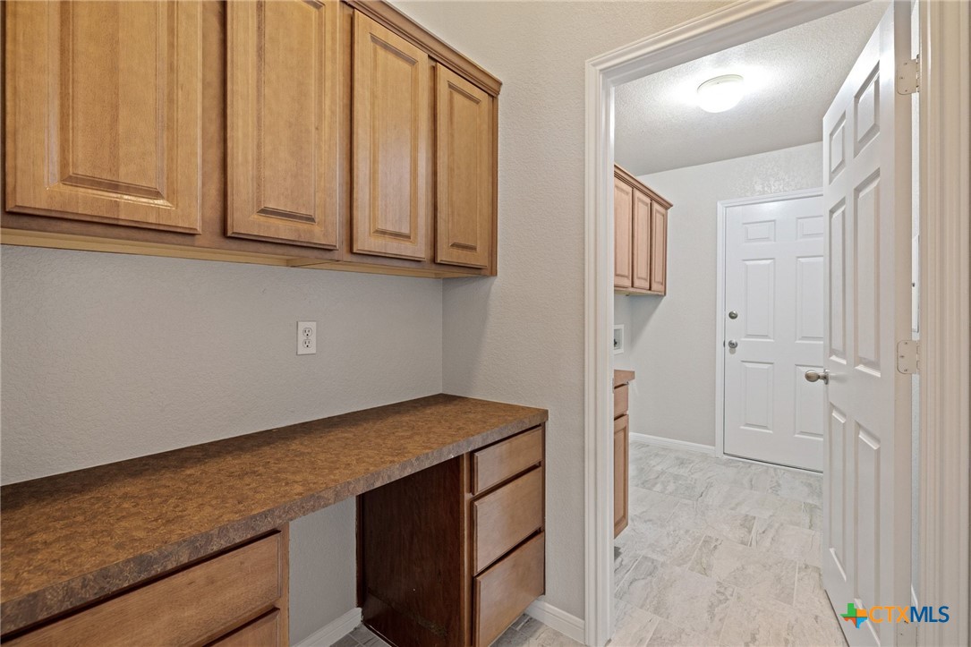 5607 Aberdeen Court Temple, TX 76502 - Photo 22 of 30 a kitchen with stainless steel appliances granite countertop a refrigerator and cabinets