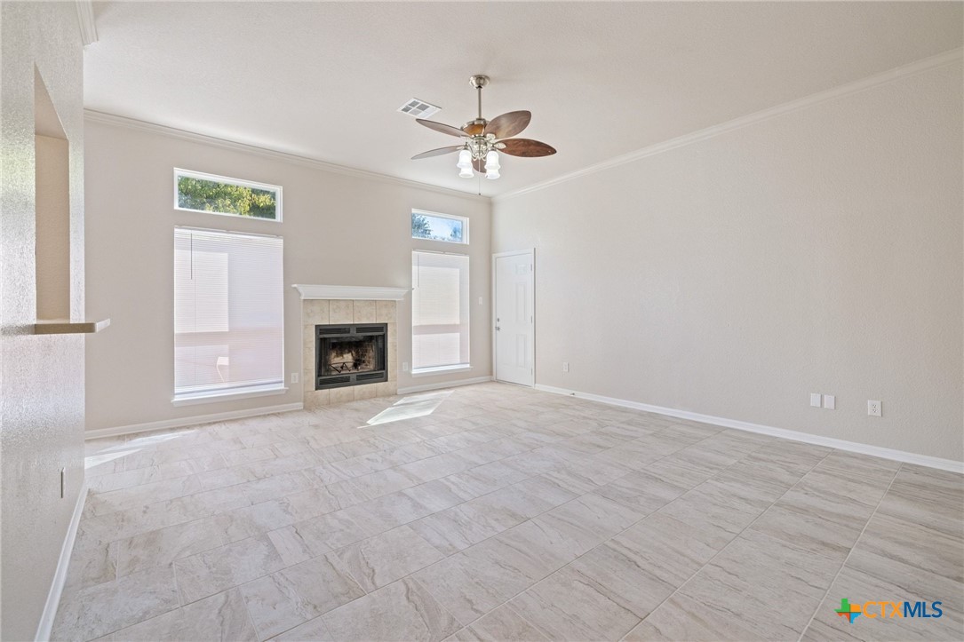 5607 Aberdeen Court Temple, TX 76502 - Photo 6 of 30 a view of an empty room with a fireplace and a window