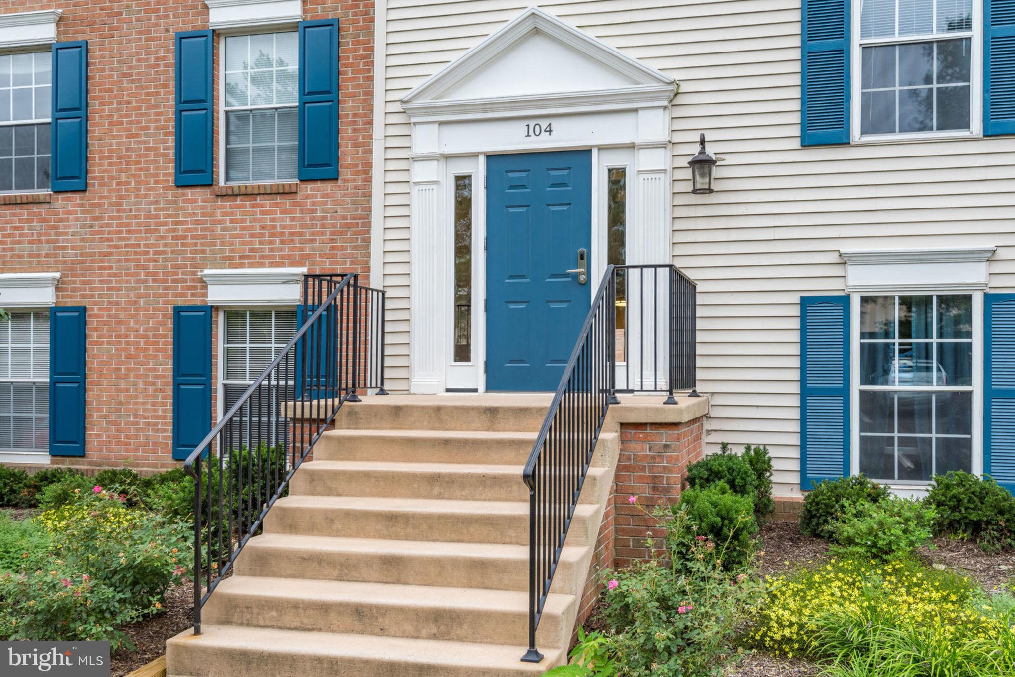 104 Fort Evans Road Southeast, Unit A Leesburg, VA 20175 - Photo 2 of 24 a front view of a house with potted plants