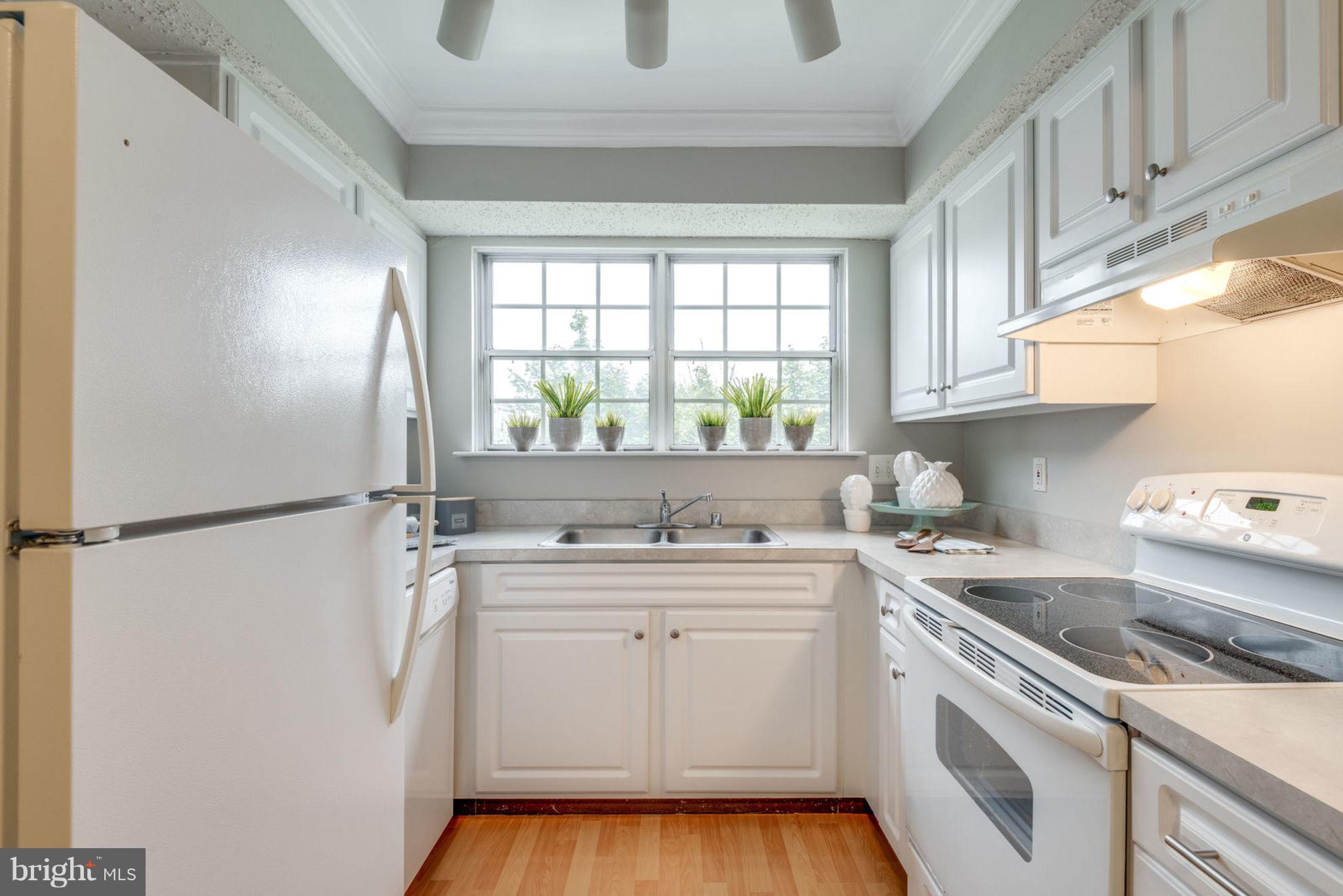 104 Fort Evans Road Southeast, Unit A Leesburg, VA 20175 - Photo 12 of 24 a kitchen with a sink a stove a refrigerator and a window