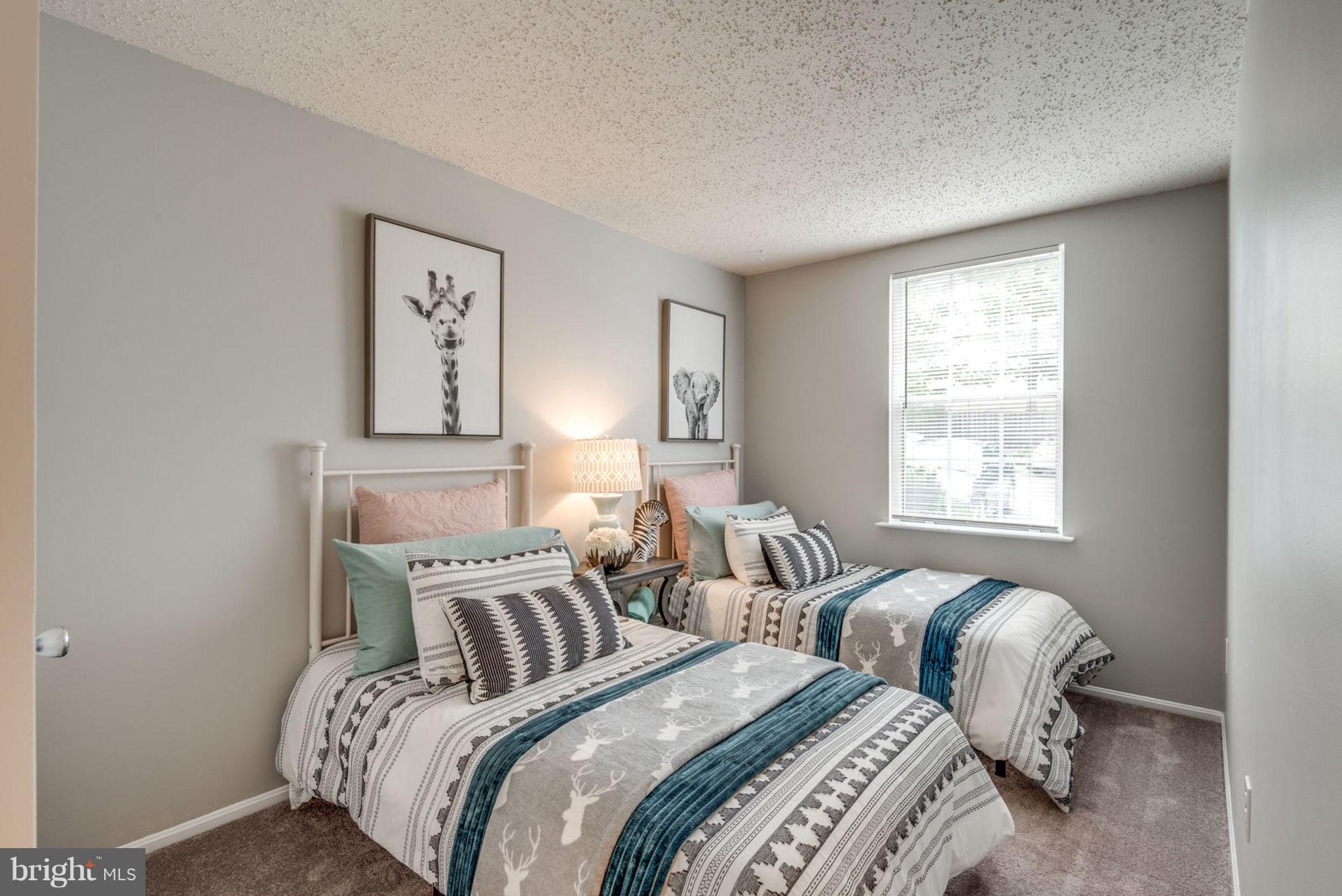 104 Fort Evans Road Southeast, Unit A Leesburg, VA 20175 - Photo 16 of 24 a bedroom with two beds and a chair