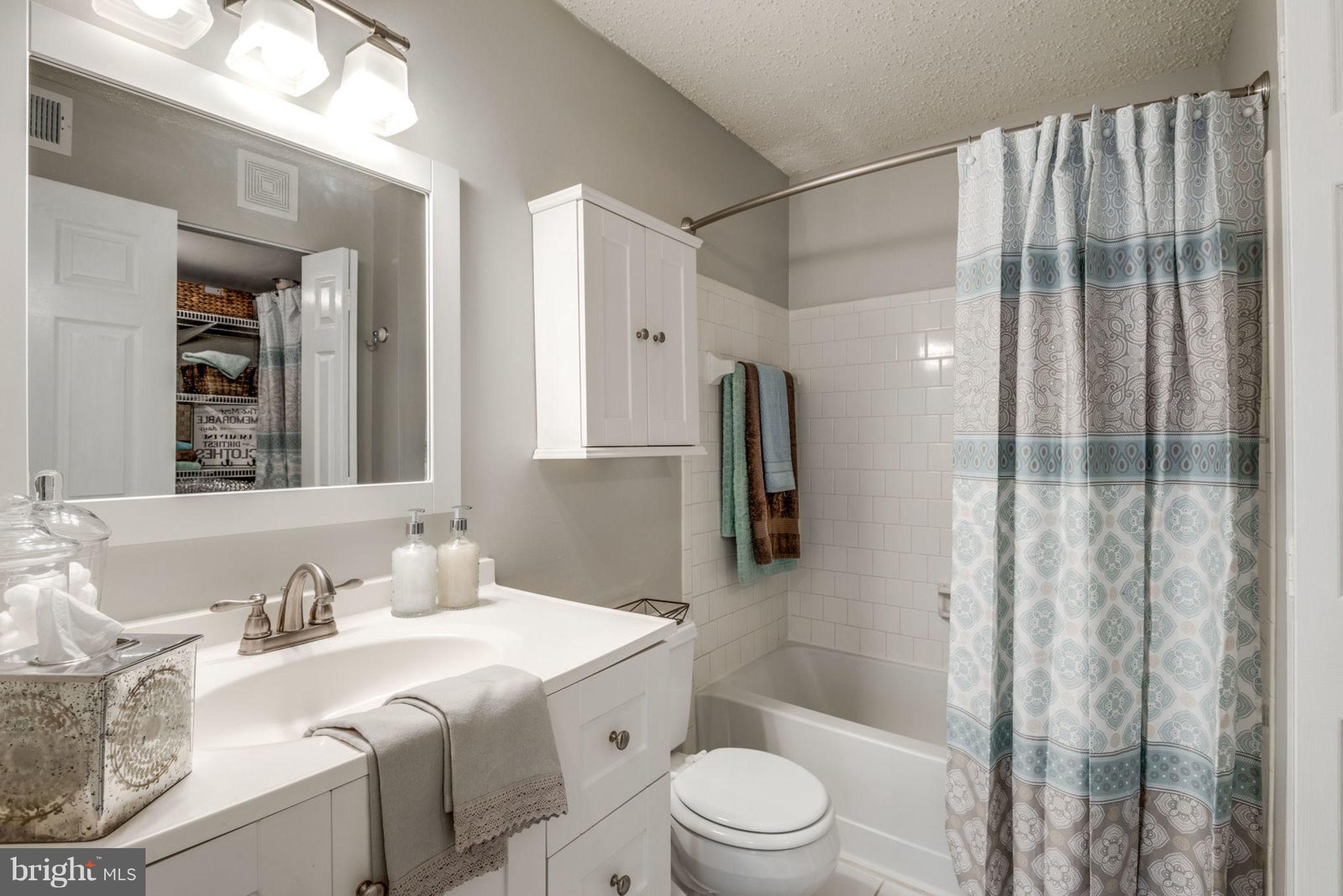 104 Fort Evans Road Southeast, Unit A Leesburg, VA 20175 - Photo 19 of 24 a bathroom with a sink toilet and shower