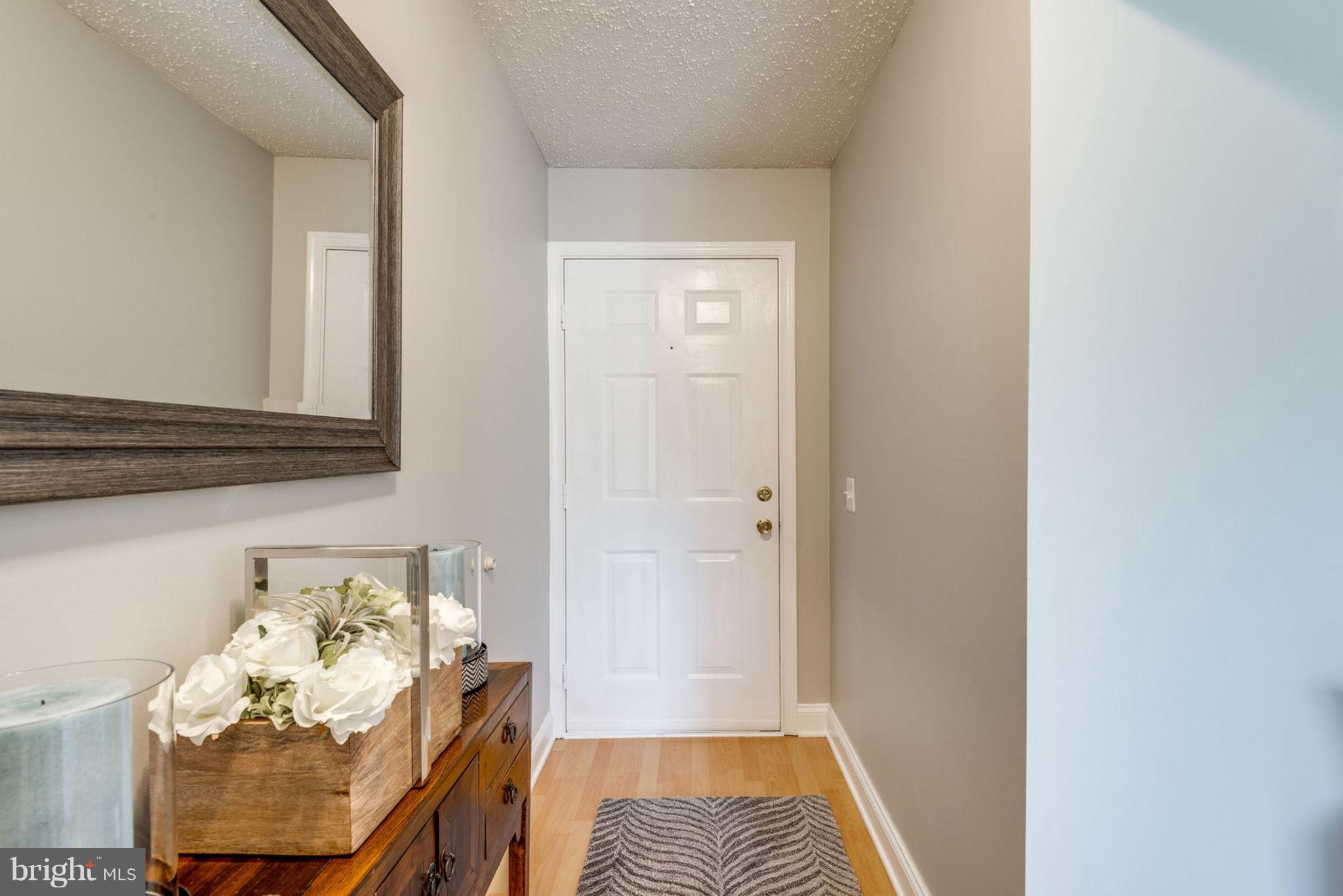 104 Fort Evans Road Southeast, Unit A Leesburg, VA 20175 - Photo 3 of 24 a view of a bedroom with wooden floor