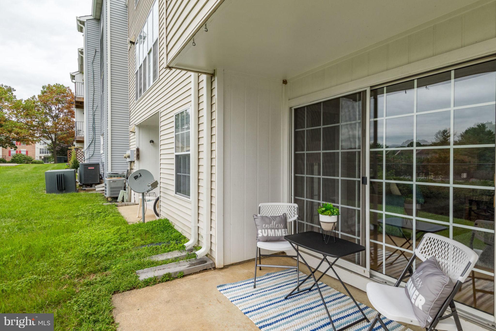 104 Fort Evans Road Southeast, Unit A Leesburg, VA 20175 - Photo 21 of 24 a view of a chair and table in backyard of the house