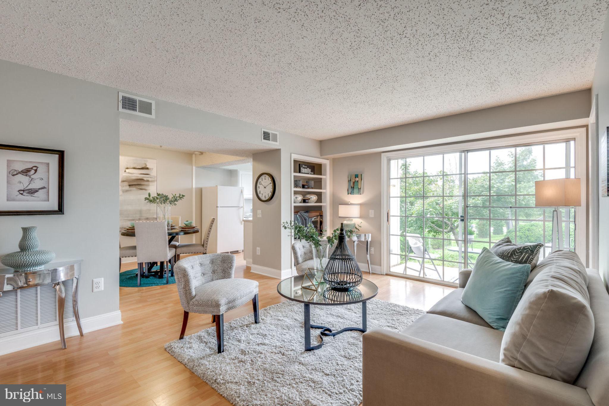 104 Fort Evans Road Southeast, Unit A Leesburg, VA 20175 - Photo 4 of 24 a living room with furniture and a large window