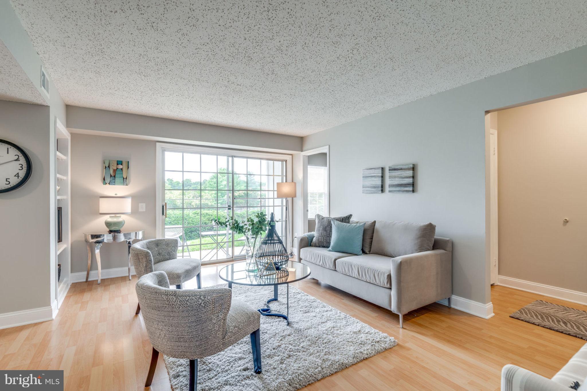 104 Fort Evans Road Southeast, Unit A Leesburg, VA 20175 - Photo 5 of 24 a living room with furniture and a large window